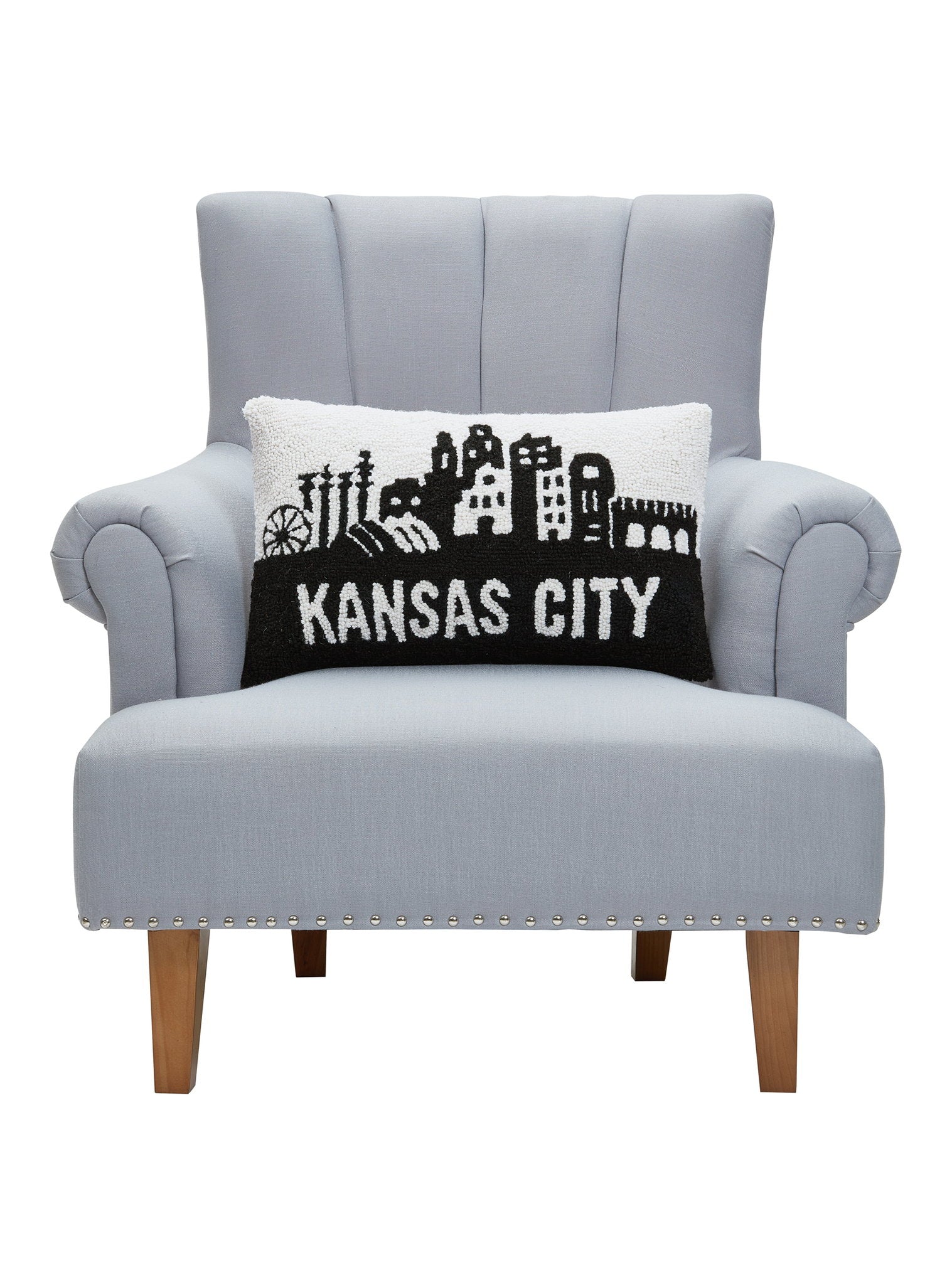 Kansas City Hooked Wool Throw Pillow on an armchair, showing the throw pillow at room scale, 12x20 inch