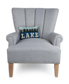 Lake Hooked Wool Throw Pillow on an armchair, showing the throw pillow at room scale, 8x12 inch