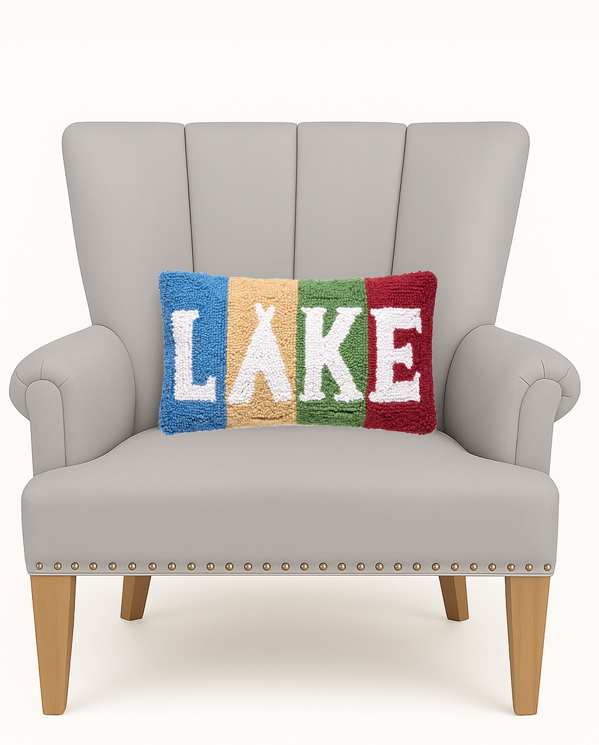 Lake Stripe Hooked Wool Throw Pillow on an armchair, showing the throw pillow at room scale, 9x16 inch
