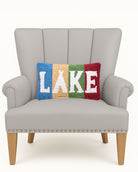Lake Stripe Hooked Wool Throw Pillow on an armchair, showing the throw pillow at room scale, 9x16 inch