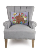Lavender Bunny Hooked Wool Easter Throw Pillow on an armchair, showing the throw pillow at room scale, 14x18 inch