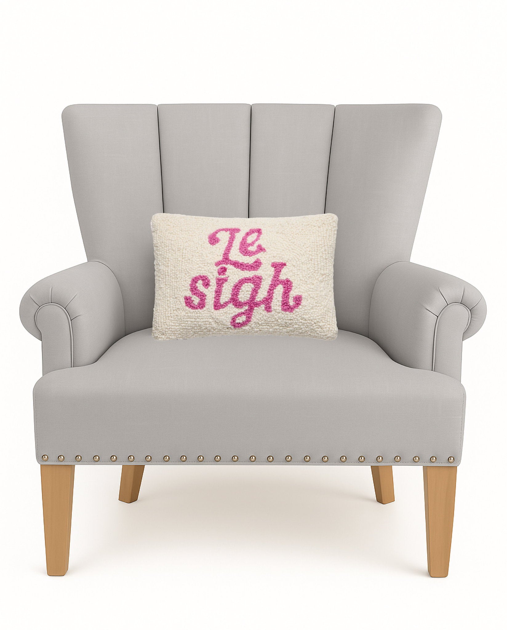 Le Sigh Hooked Wool Throw Pillow on an armchair, showing the throw pillow at room scale, 8x12 inch