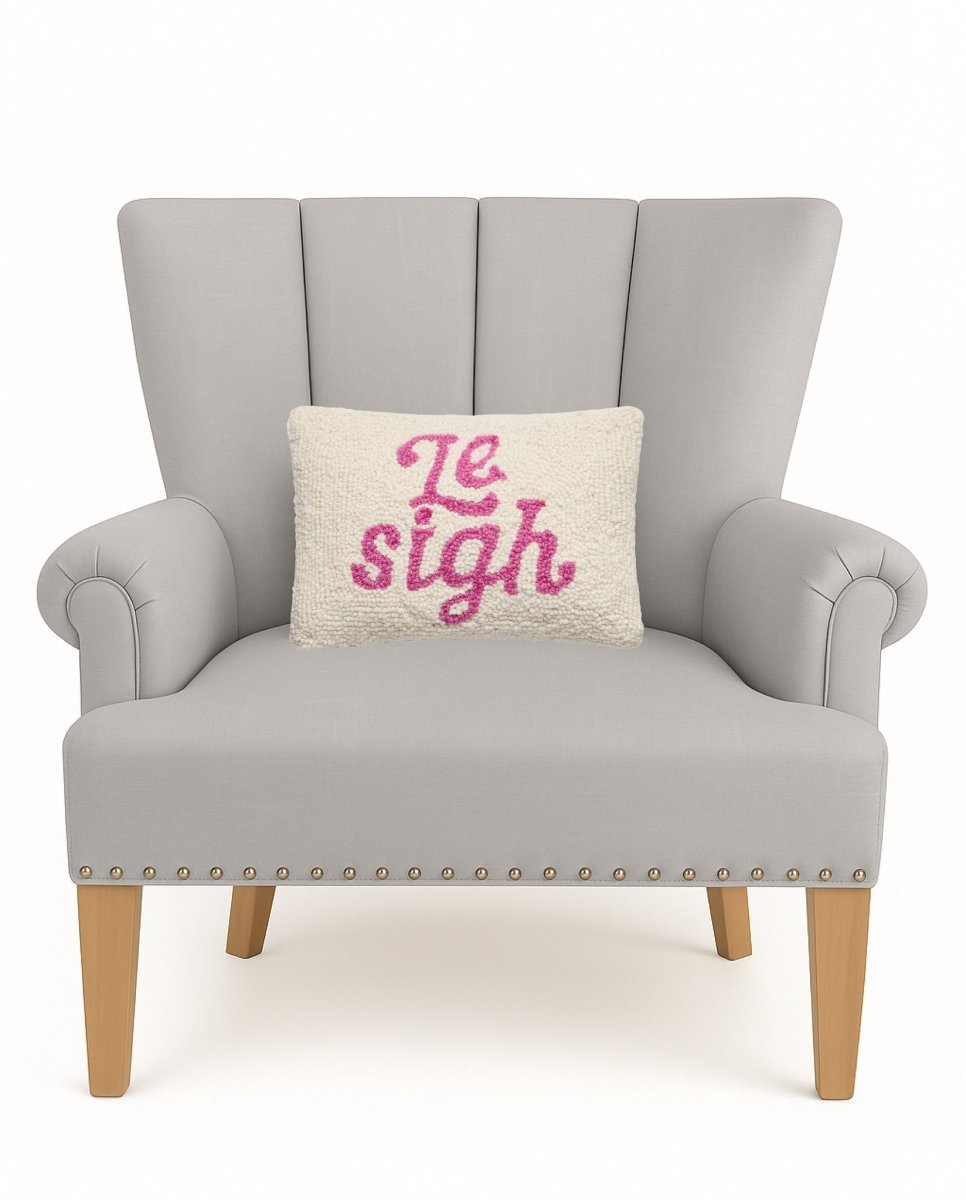 Le Sigh Hooked Wool Throw Pillow on an armchair, showing the throw pillow at room scale, 8x12 inch