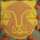 Closeup of Leo with Tassels Hooked Wool Throw Pillow showing stitch texture and craftsmanship detail
