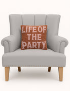Life of the Party Hooked Wool Throw Pillow on an armchair, showing the throw pillow at room scale, 12x12 inch