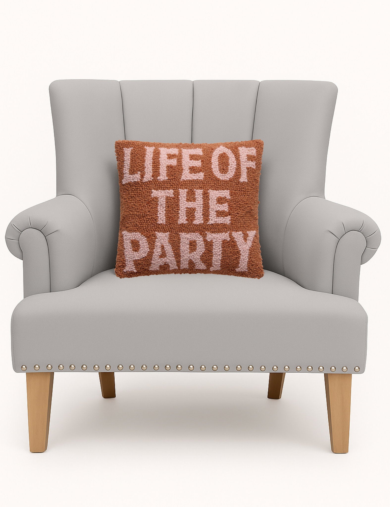 Life of the Party Hooked Wool Throw Pillow on an armchair, showing the throw pillow at room scale, 12x12 inch
