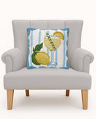 Limoncello Spritz Hooked Wool Throw Pillow on an armchair, showing the throw pillow at room scale, 16x16 inch