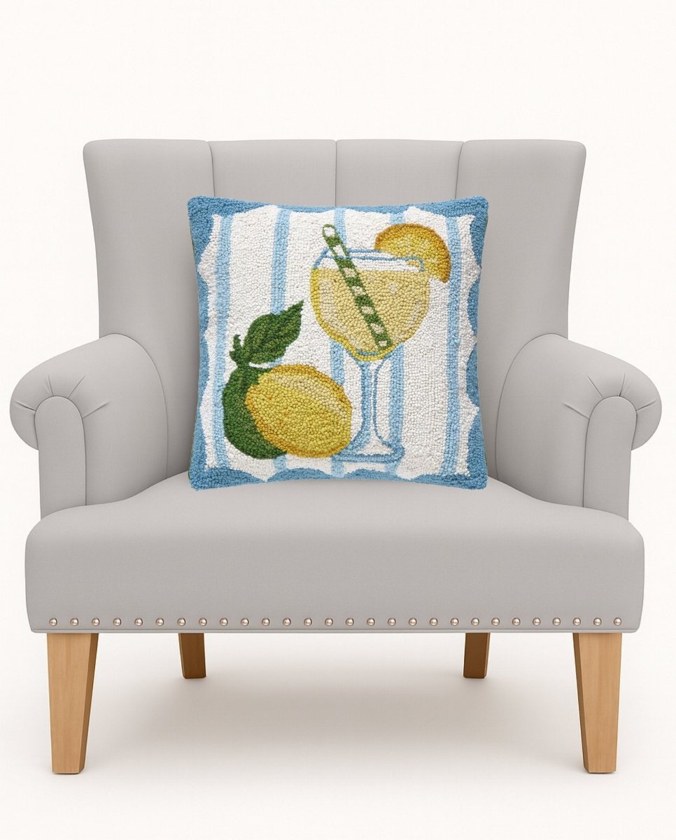 Limoncello Spritz Hooked Wool Throw Pillow on an armchair, showing the throw pillow at room scale, 16x16 inch
