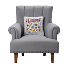 Louisiana Embroidered Throw Pillow on an armchair, showing the throw pillow at room scale, 14x14 inch