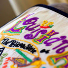 Louisiana State Jazz Travel Embroidered Throw Pillow - close-up detail of hand-embroidered needlepoint stitching