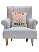 Love and Peace Hooked Wool Throw Pillow on an armchair, showing the throw pillow at room scale, 16x16 inch