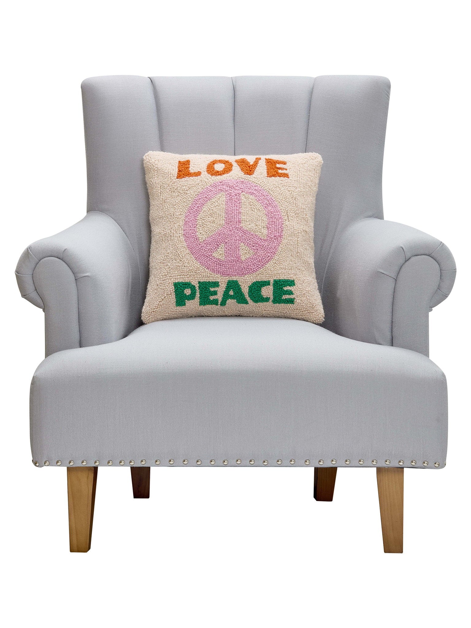 Love and Peace Hooked Wool Throw Pillow on an armchair, showing the throw pillow at room scale, 16x16 inch