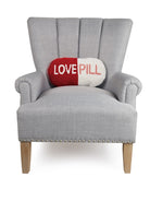 Love Pill Shaped Hooked Wool Throw Pillow on an armchair, showing the throw pillow at room scale, 9x16 inch