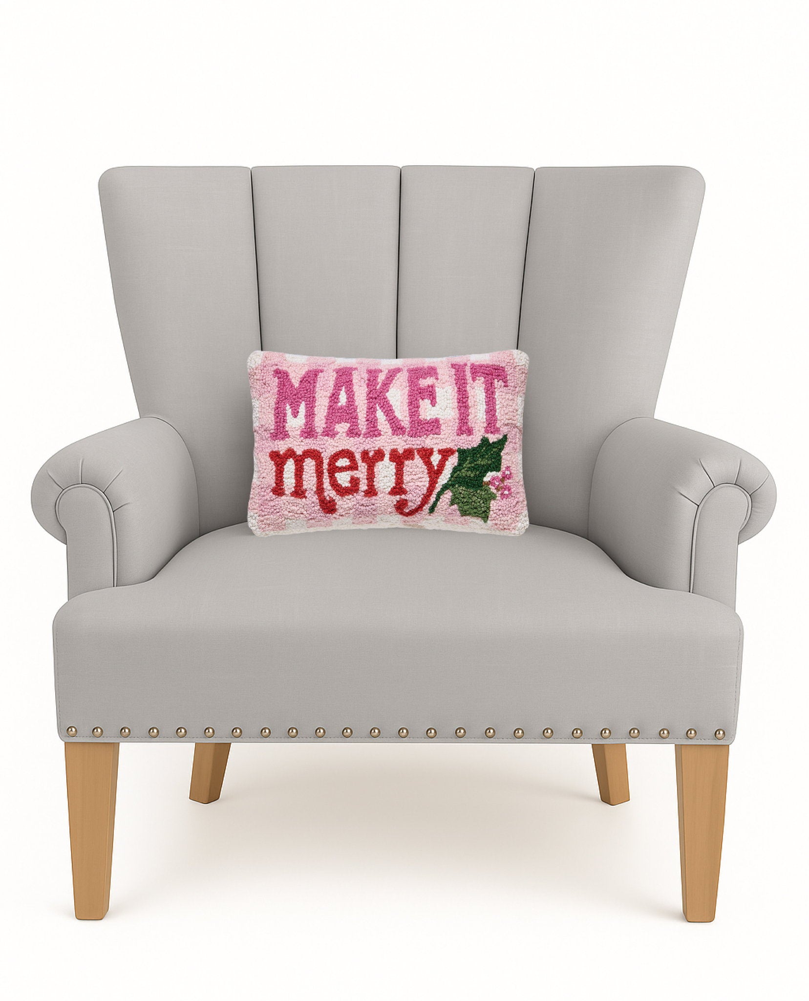 Make It Merry Hooked Wool Christmas Throw Pillow on an armchair, showing the throw pillow at room scale, 9x16 inch