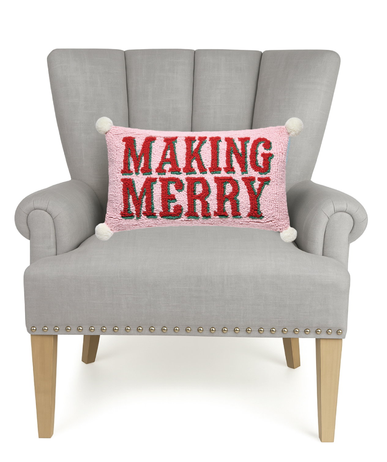 Making Merry with Pom Poms Hooked Wool Christmas Throw Pillow on an armchair, showing the throw pillow at room scale, 9x16 inch