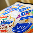 Malibu Beach, CA Surf City Embroidered Travel Pillow - close-up detail of hand-embroidered needlepoint stitching