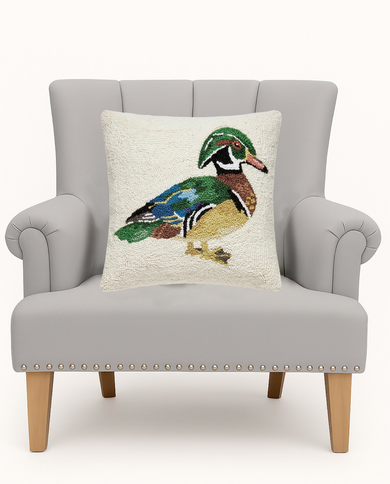 Mallard Hooked Wool Throw Pillow on an armchair, showing the throw pillow at room scale, 16x16 inch