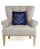 Menorah Gold Embroidered Hanukkah Throw Pillow on an armchair, showing the throw pillow at room scale, 12x12 inch