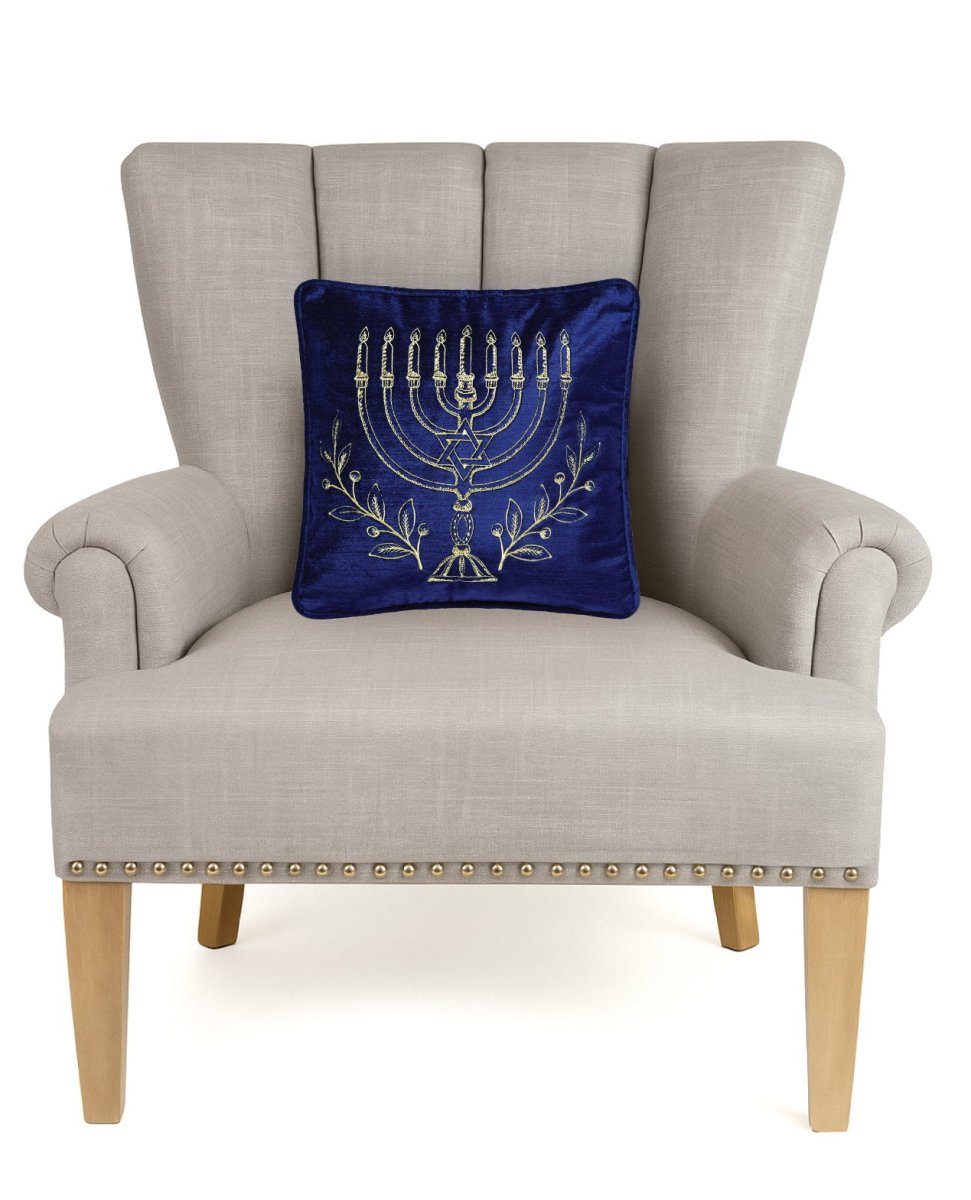 Menorah Gold Embroidered Hanukkah Throw Pillow on an armchair, showing the throw pillow at room scale, 12x12 inch
