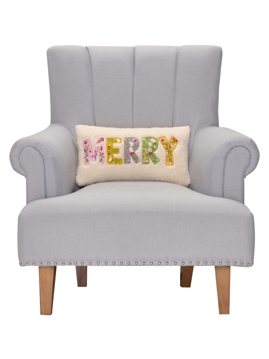 Merry Applique Embroidered Christmas Throw Pillow on an armchair, showing the throw pillow at room scale, 9x16 inch