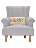 Merry Applique Embroidered Christmas Throw Pillow on an armchair, showing the throw pillow at room scale, 9x16 inch