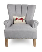 Merry Hooked Wool Christmas Throw Pillow on an armchair, showing the throw pillow at room scale, 8x12 inch