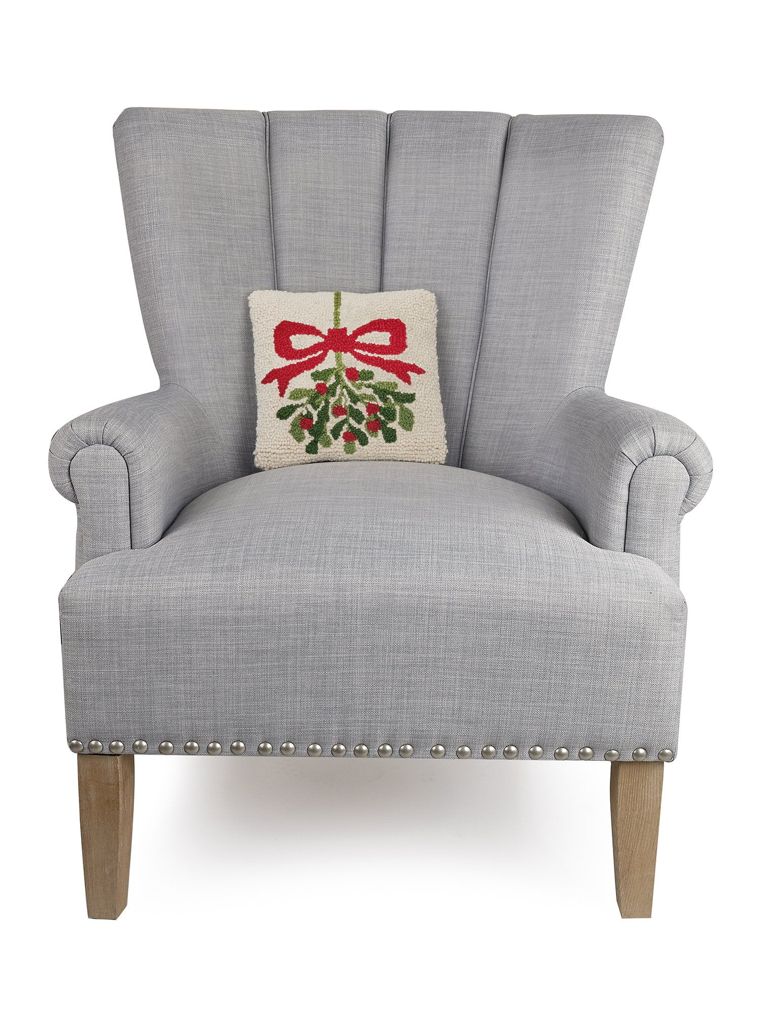 Mistletoe Hooked Wool Christmas Throw Pillow on an armchair, showing the throw pillow at room scale, 10x10 inch