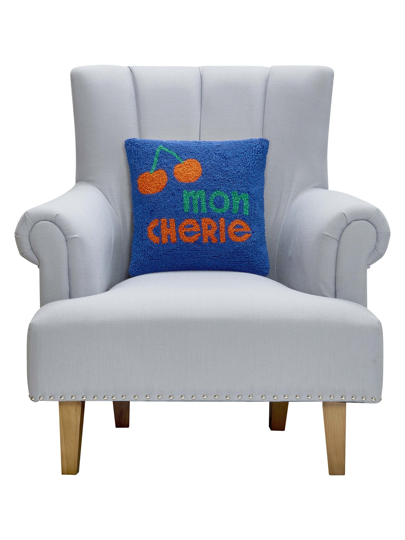 Mon Cherie Hooked Wool Throw Pillow on an armchair, showing the throw pillow at room scale, 14x14 inch