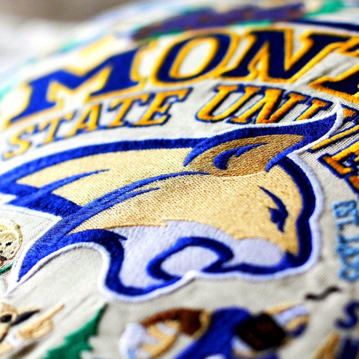 Montana State University Bobcats Embroidered College Pillow - close-up detail of hand-embroidered needlepoint stitching