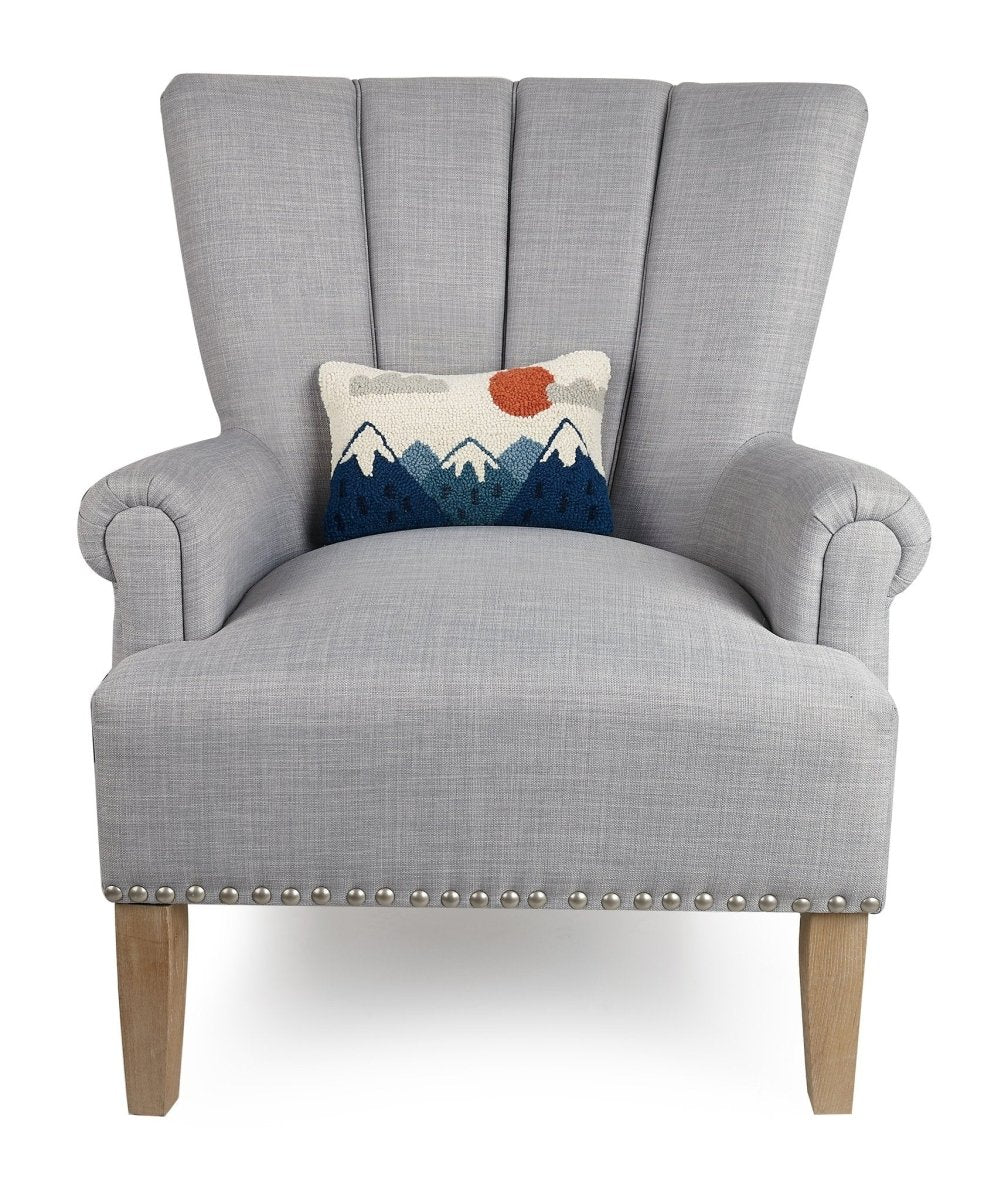 Mountains Hooked Wool Throw Pillow on an armchair, showing the throw pillow at room scale, 8x12 inch