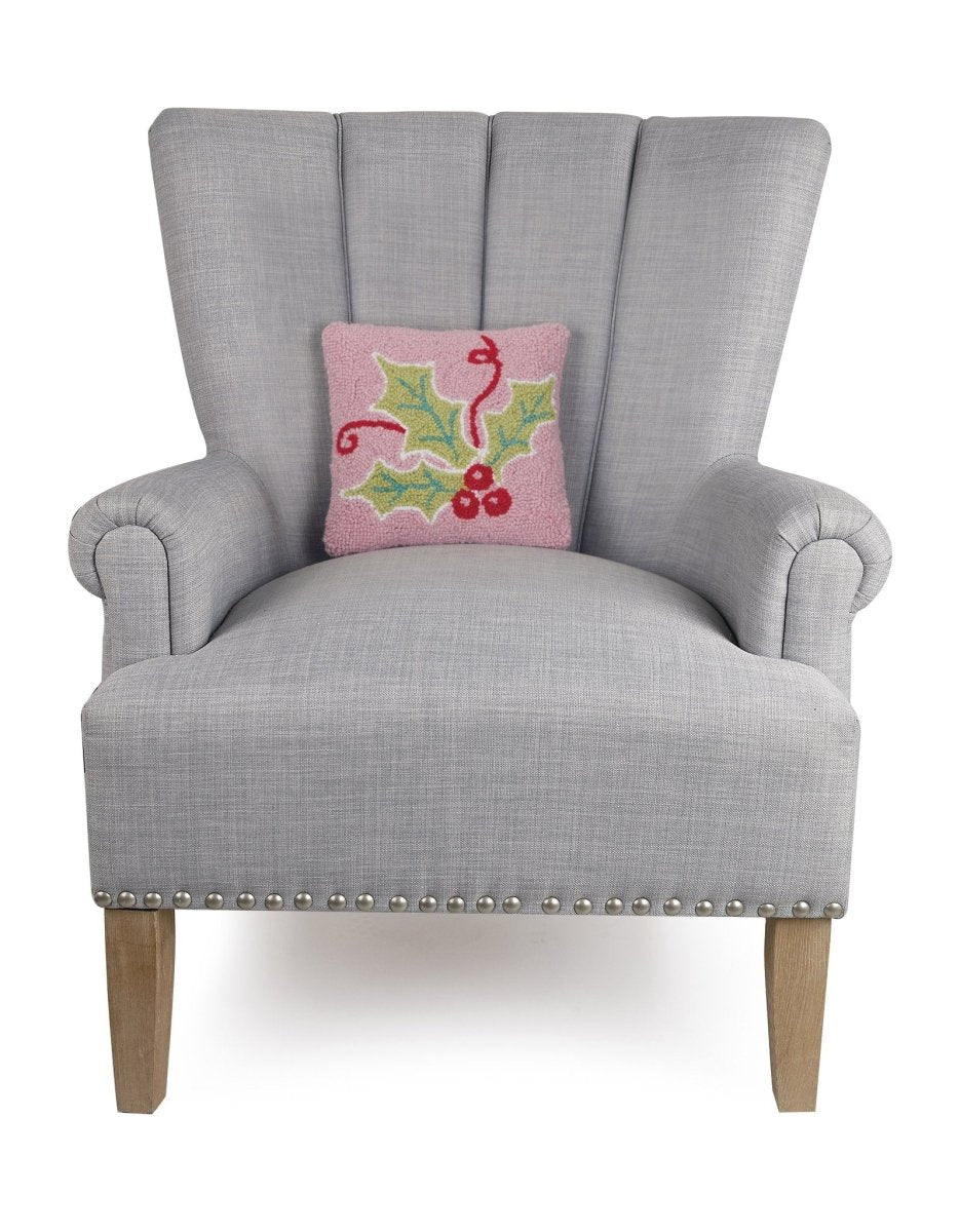 Multi Color Holly Hooked Wool Christmas Throw Pillow on an armchair, showing the throw pillow at room scale, 10x10 inch