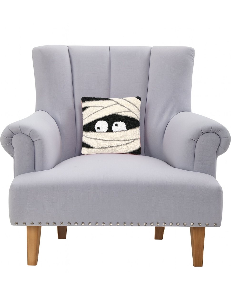 Mummy Face Hooked Wool Halloween Throw Pillow on an armchair, showing the throw pillow at room scale, 10x10 inch
