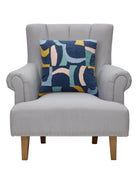Navy & Bright Shapes Embroidered Throw Pillow on an armchair, showing the throw pillow at room scale, 18x18 inch