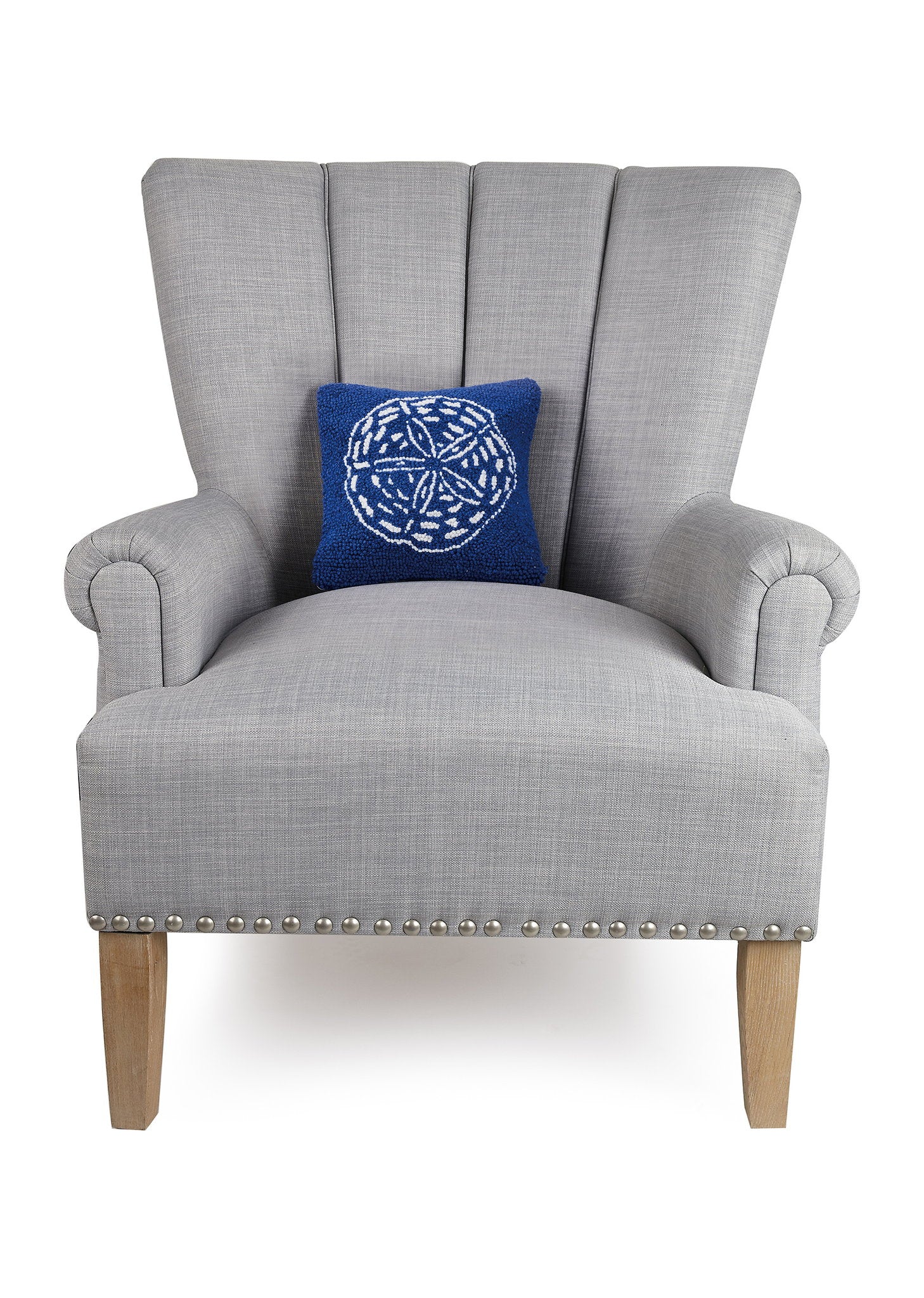 Navy Ground Sand Dollar Hooked Wool Throw Pillow on an armchair, showing the throw pillow at room scale, 10x10 inch
