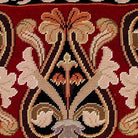 Closeup of Neogothic Red Fleur De Lis needlepoint throw pillow highlighting hand-stitched wool craftsmanship and fabric detail