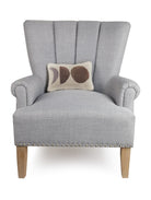 Neutral Moons Hooked Wool Throw Pillow on an armchair, showing the throw pillow at room scale, 8x12 inch