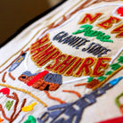 New Hampshire State Granite Travel Embroidered Throw Pillow - close-up detail of hand-embroidered needlepoint stitching