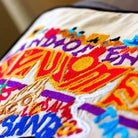 New Mexico State Enchantment Travel Embroidered Throw Pillow - close-up detail of hand-embroidered needlepoint stitching