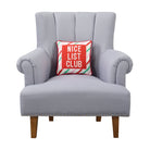 Nice List Club Embroidered Needlepoint Christmas Throw Pillow on an armchair, showing the throw pillow at room scale, 12x12 inch
