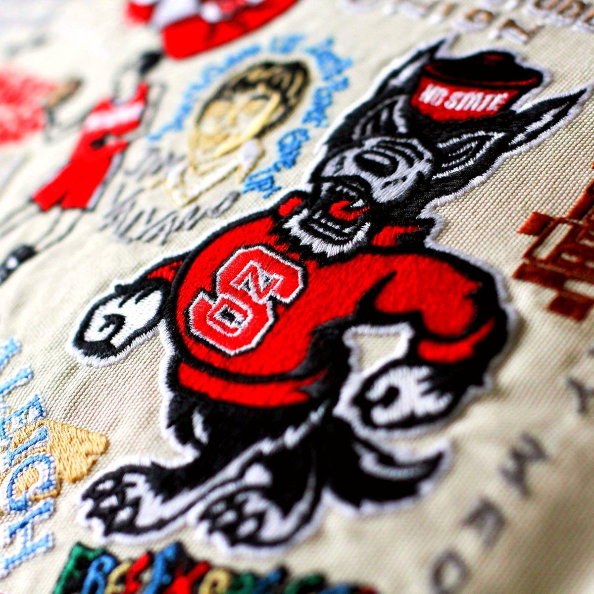 North Carolina State University Wolfpack Embroidered Pillow - close-up detail of hand-embroidered needlepoint stitching