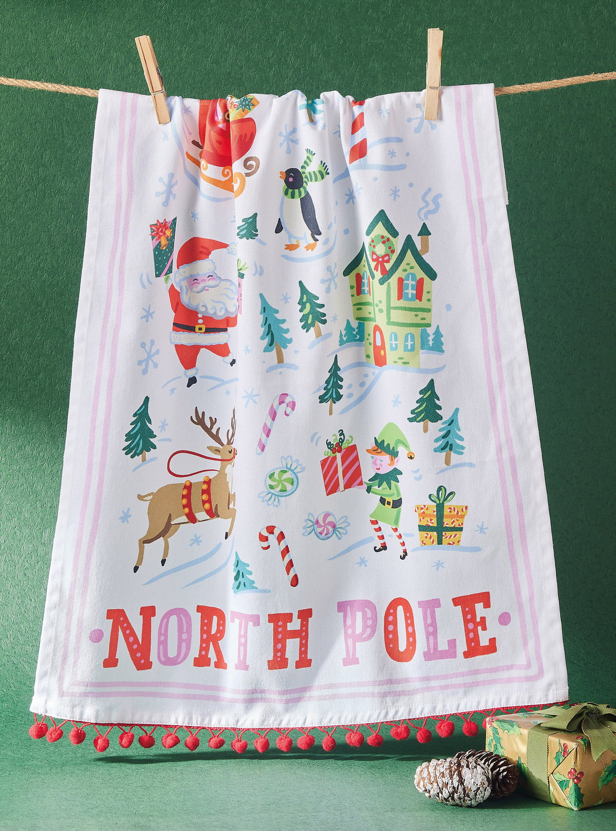 North Pole with Pom Poms Christmas Kitchen Towel styled in a room setting, 18x25 inch