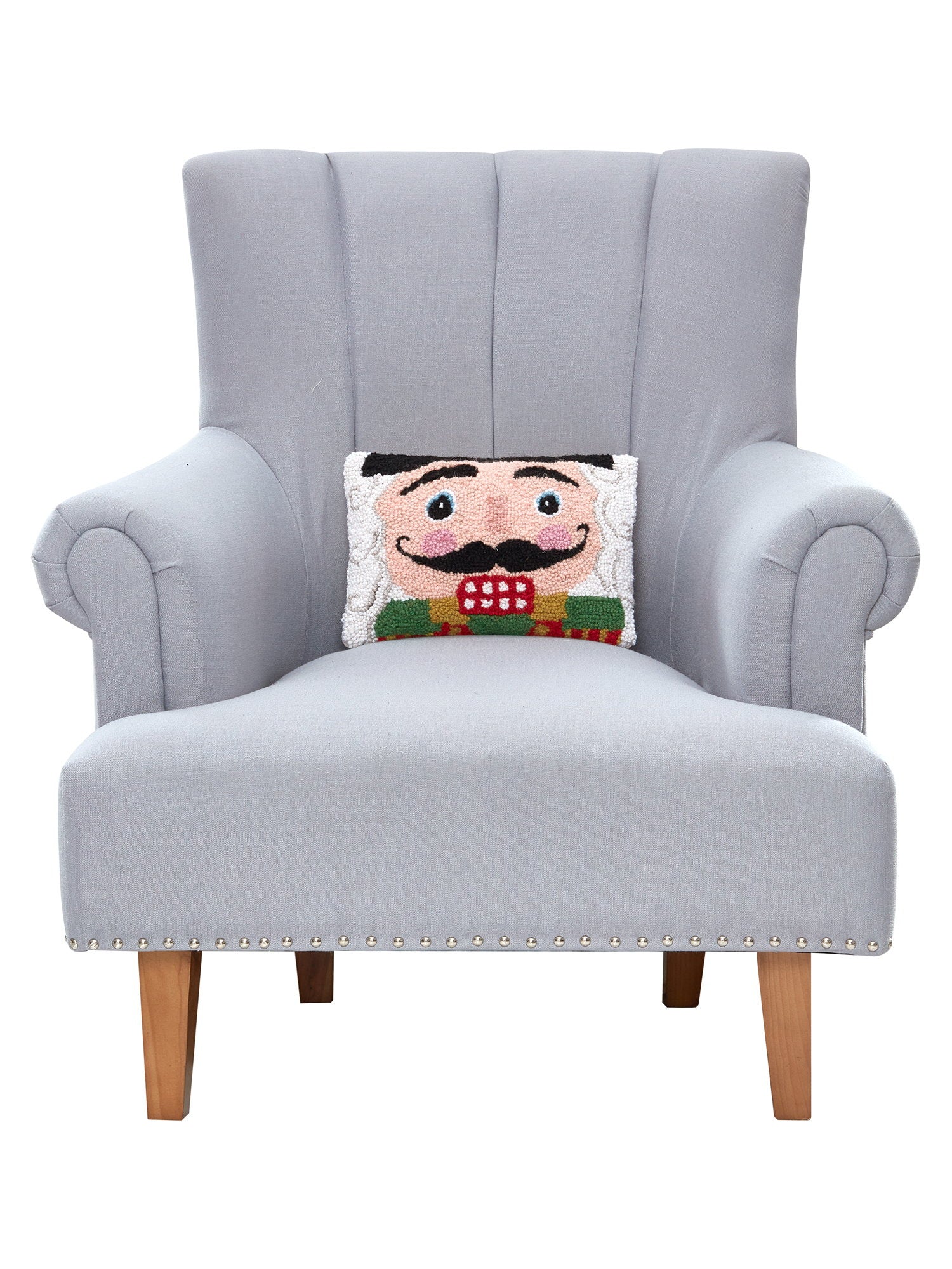 Nutcracker Face Hooked Wool Christmas Throw Pillow on an armchair, showing the throw pillow at room scale, 8x12 inch