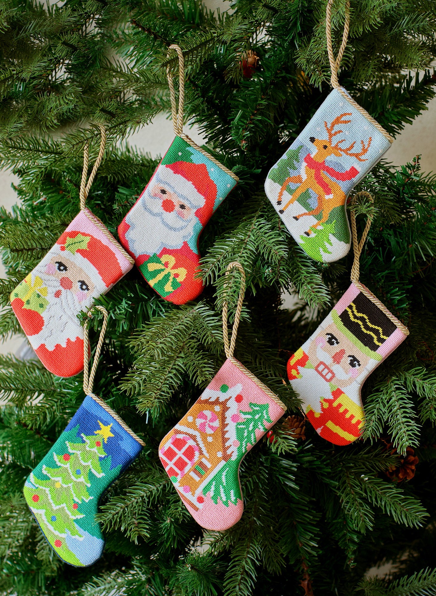 Nutcracker Portrait Mini Embroidered Needlepoint Christmas Stocking, 6x4 inch, five mini stockings hanging on evergreen branches