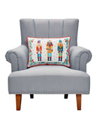 Nutcrackers Printed Christmas Throw Pillow on an armchair, showing the throw pillow at room scale, 14x20 inch