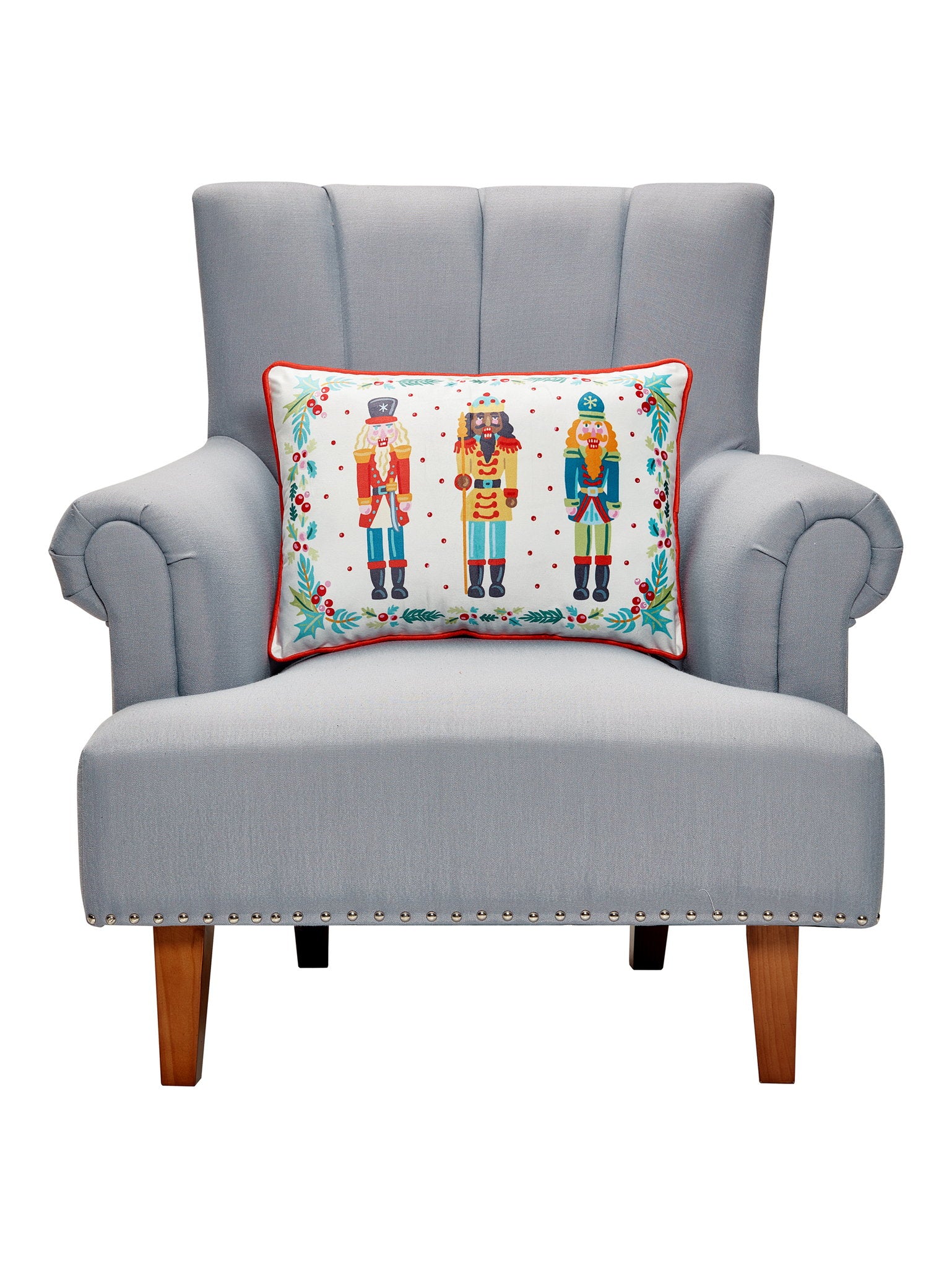 Nutcrackers Printed Christmas Throw Pillow on an armchair, showing the throw pillow at room scale, 14x20 inch