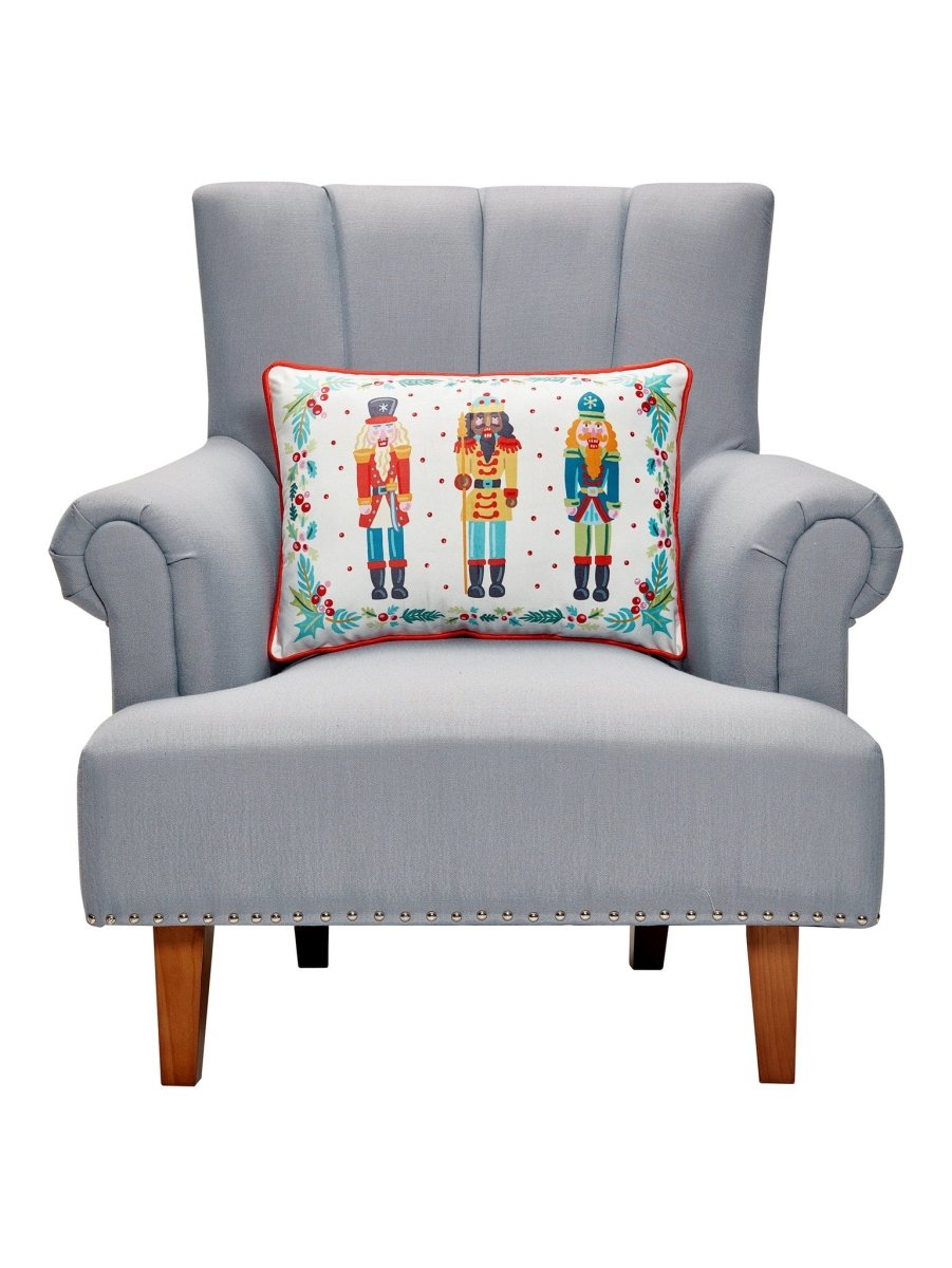 Nutcrackers Printed Christmas Throw Pillow on an armchair, showing the throw pillow at room scale, 14x20 inch