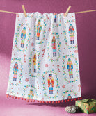 Nutcrackers with Pom Pom Christmas Kitchen Towel styled in a room setting, 18x25 inch
