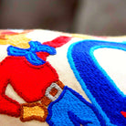 Oklahoma City, OK Frontier City Embroidered Travel Pillow - close-up detail of hand-embroidered needlepoint stitching