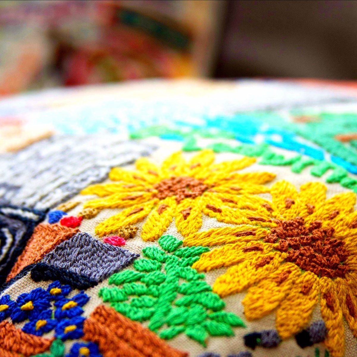 Omaha, NE Gateway City Embroidered Travel Throw Pillow - close-up detail of hand-embroidered needlepoint stitching