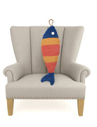 Orange Picket Fish Hooked Wool Throw Pillow on an armchair, showing the throw pillow at room scale, 8x22 inch